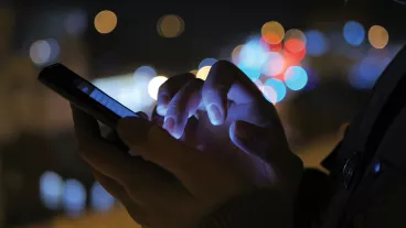 Close-up shot of woman hands with smartphone in the city at night. Close-up shot of woman hands with smartphone in the city at night.