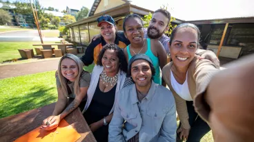 Young First Australian students and their tutor taking a selfie together outdoors in Australia. Young First Australian students and their tutor taking a selfie together outdoors in Australia.