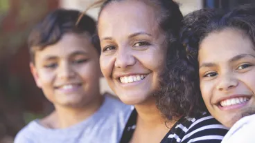 Aboriginal Family portrait with 1 parent and 2 children.