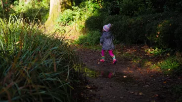 Side View Of A Young Girl Walking In The Park