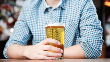 Young man in bar, mid section