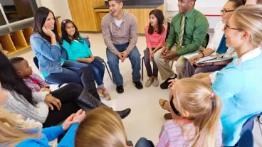 Conference or meeting with elementary school teachers students and parents