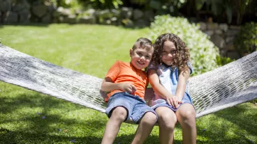 First Nations' Australian children playing in hammock