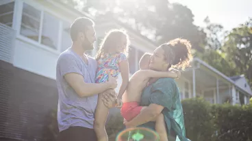 Australian aboriginal family enjoying in the garden at home on a sunny day