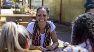 Close-up of young aboriginal students studying together outdoors in the sun in Australia.