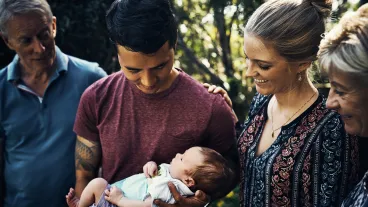 Shot of a young couple introducing their newborn baby son to his grandparents