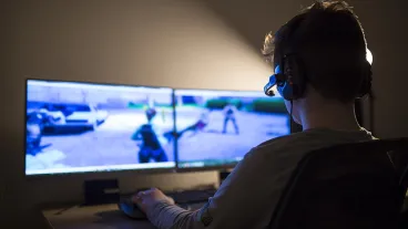 Young boy playing games on a computer at home