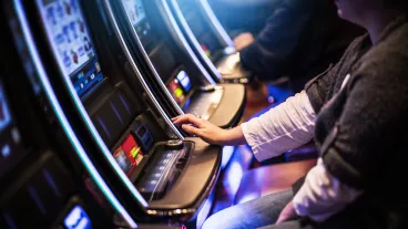 Casino Slot Gamblers. People Playing Video Slot Machines Inside Las Vegas Located Casino.