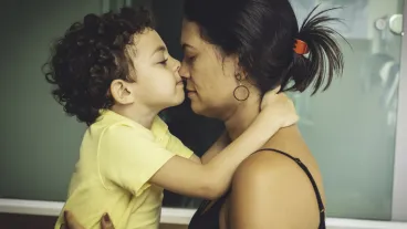 Mother and son embracing.