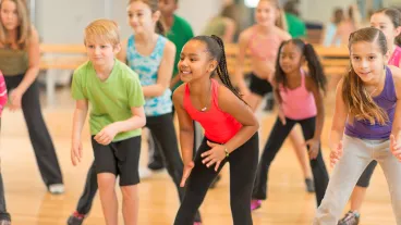 Diverse group of children in a dance fitness class