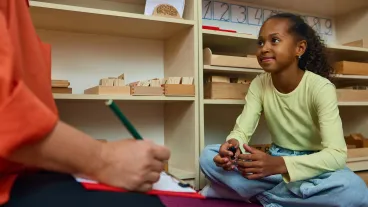 Girl talking with child psychologist in therapy session