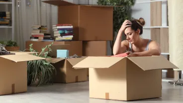  Sad evicted tenant moving home boxing belongings