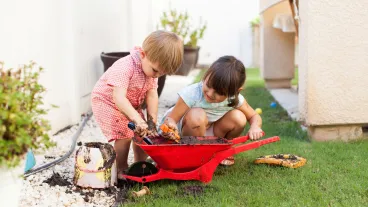 Children playing in garden with mud