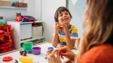 Mother and son playing with child's play clay.
