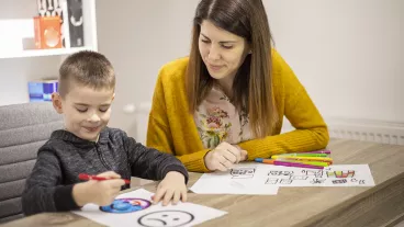 Five year old boy drawing at his educator's office.