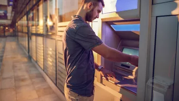 Businessman withdrawing cash from a bank's ATM