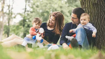 Family portrait of happy parents with kids enjoying spring time in nature 