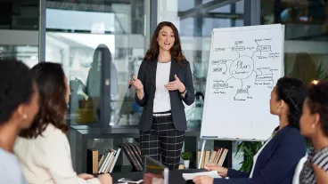 Shot of a young businesswoman giving a presentation in the boardroom Shot of a young businesswoman giving a presentation in the boardroom