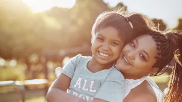 Portrait of a mother bonding with her daughter outdoors