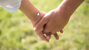 Closeup photo of a teenage couple holding hands Closeup photo of a teenage couple holding hands