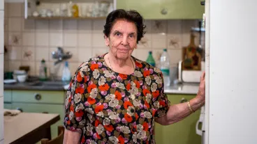 Smiling Senior Woman Looking Out Of Window