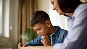 Mother helping her son with homework