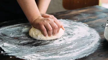 Close up stock photo of a woman kneading dough