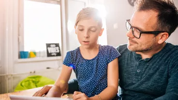 Father and daughter using tablet