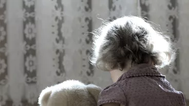 Depressed little girl hug a teddy bear