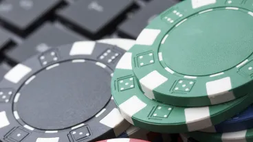Casino gambling chips on computer keyboard.