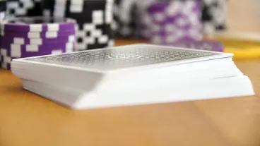 An image of poker cards and casino chips in the background