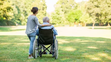 rear view of girl with wheelchair bound adult