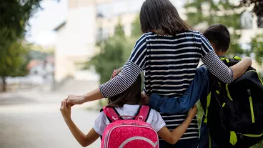 Mother taking kids to school