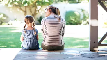Rearview shot of a young woman and her daughter having a conversation on the porch