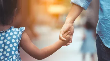 Mother and daughter holding hand together in vintage color tone