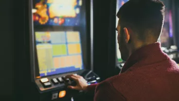 Man at pokie machine