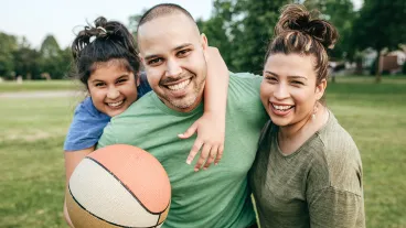 Family of three playing basketball