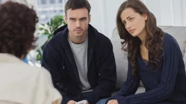 Couple sitting on couch listening to therapist