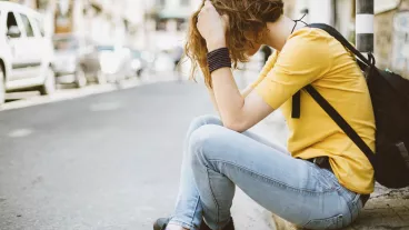 Depressed girl sitting on ground