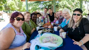A group of multicultural people sitting around a table and having lunch