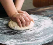 Close up stock photo of a woman kneading dough